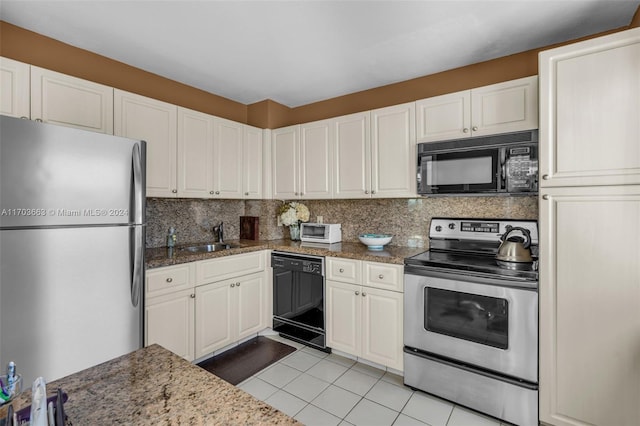 kitchen featuring black appliances, white cabinetry, sink, and dark stone counters