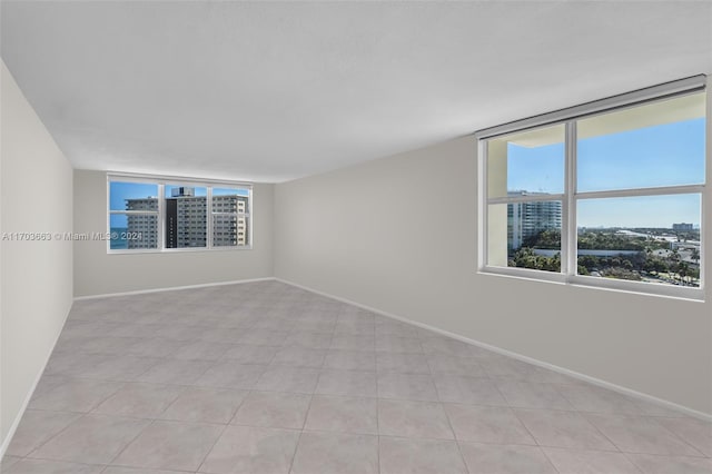 spare room featuring light tile patterned floors