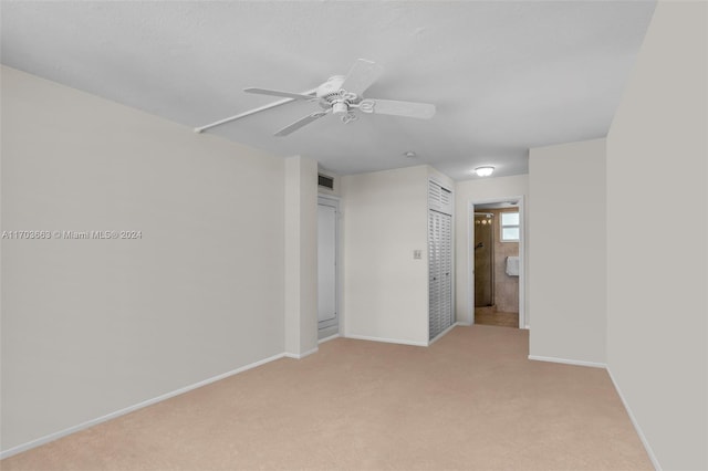 unfurnished room with ceiling fan and light carpet