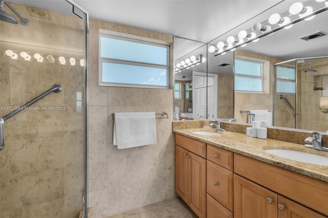 bathroom featuring vanity, tile patterned floors, and walk in shower