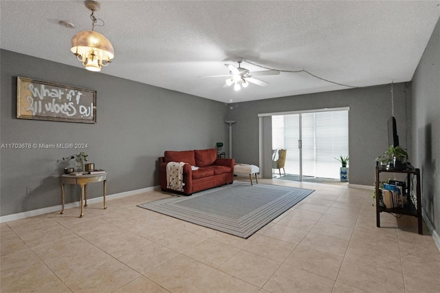 tiled living room with ceiling fan and a textured ceiling