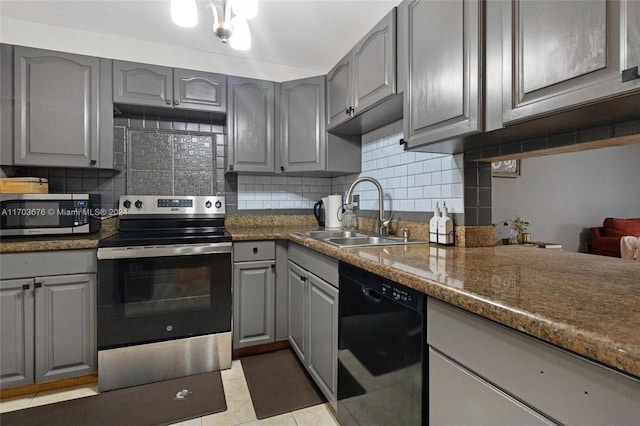 kitchen featuring gray cabinetry, sink, appliances with stainless steel finishes, tasteful backsplash, and light tile patterned flooring