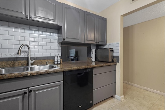 kitchen featuring sink, decorative backsplash, gray cabinets, light tile patterned floors, and black dishwasher