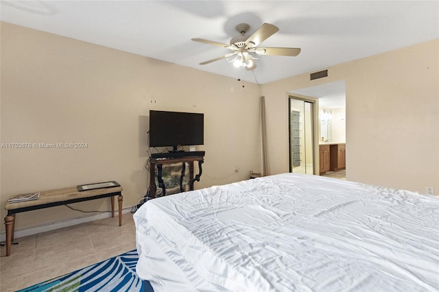 bedroom featuring ceiling fan, light tile patterned floors, and connected bathroom