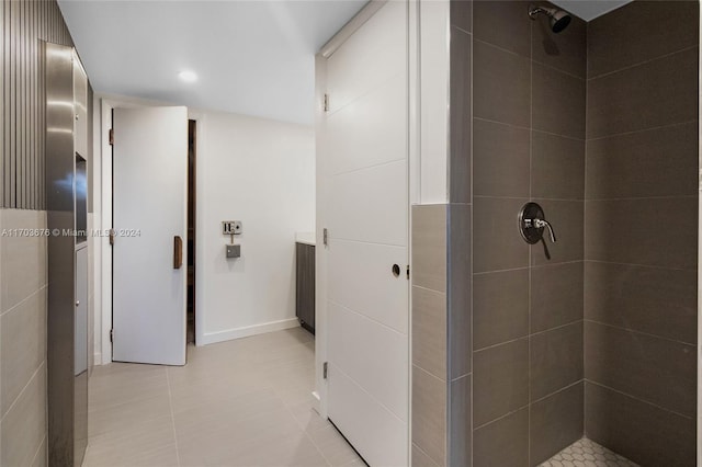 bathroom with tiled shower and tile patterned floors