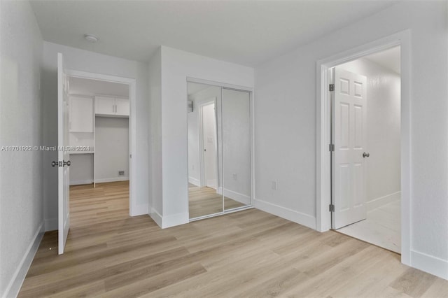 unfurnished bedroom with light wood-type flooring