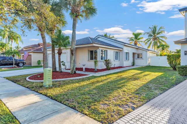 single story home with a front lawn and a garage