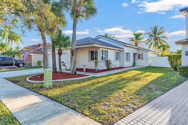 single story home with a garage and a front lawn