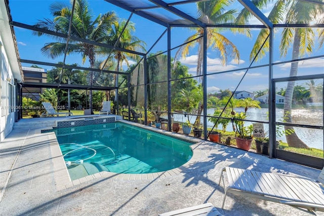 view of pool with a patio, a water view, and glass enclosure