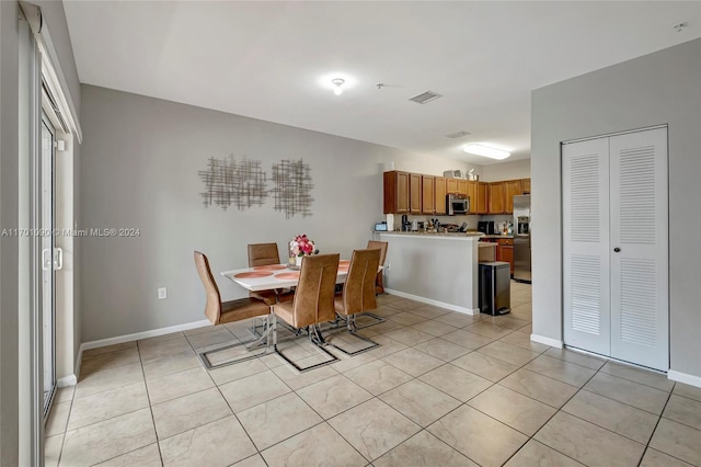 dining area with light tile patterned flooring