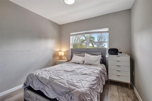 bedroom with hardwood / wood-style floors