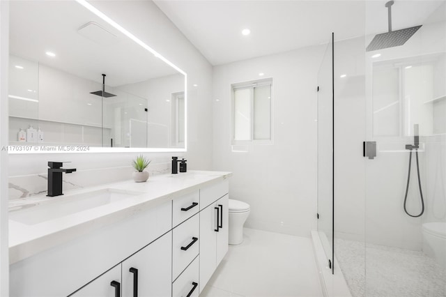 bathroom featuring tile patterned flooring, vanity, toilet, and walk in shower