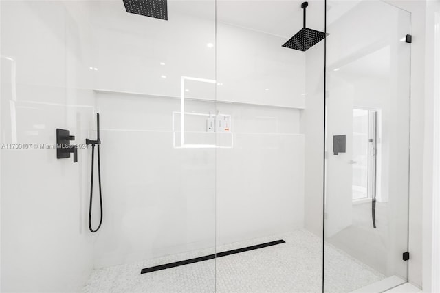 bathroom with a shower with door