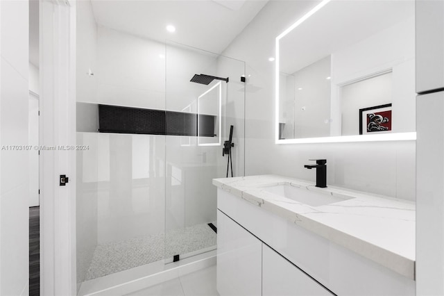 bathroom with vanity and tiled shower