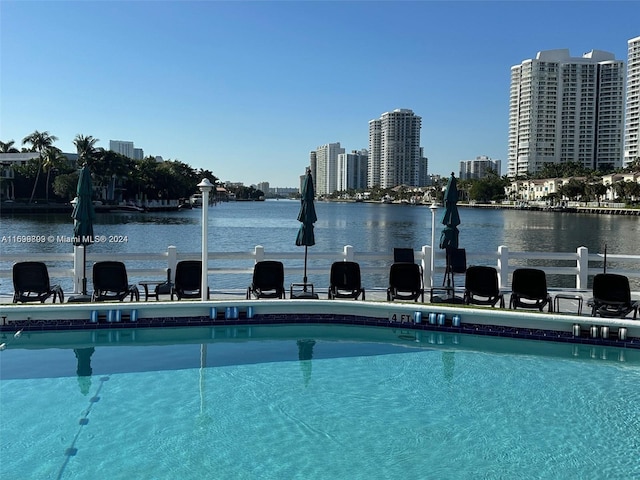 view of pool with a water view