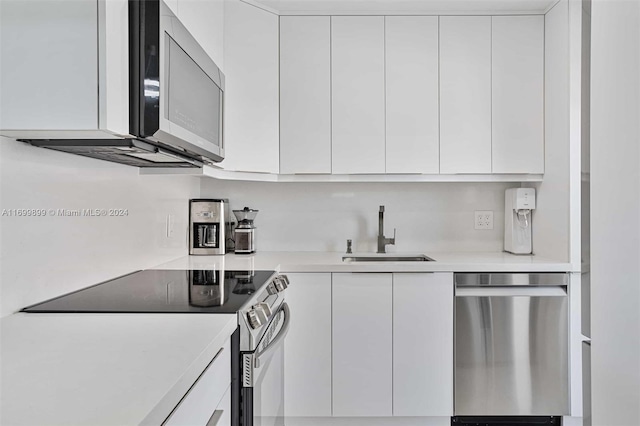 kitchen featuring sink, white cabinets, and stainless steel appliances