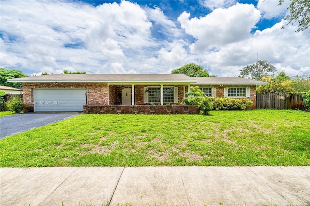 ranch-style home with a garage and a front lawn