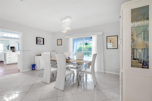 dining area featuring a notable chandelier and light tile patterned floors