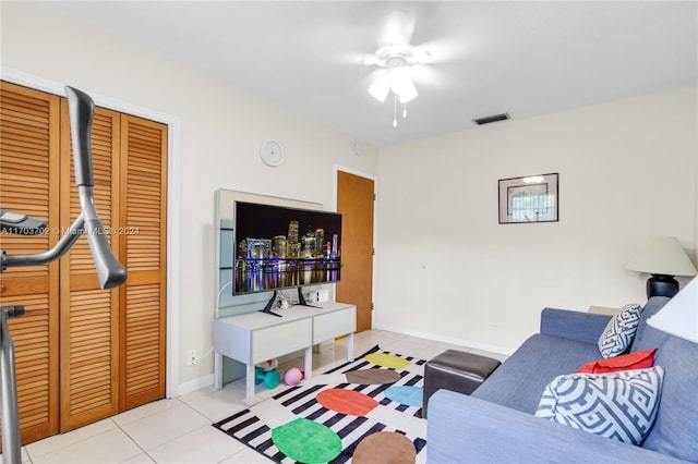 tiled living room with ceiling fan