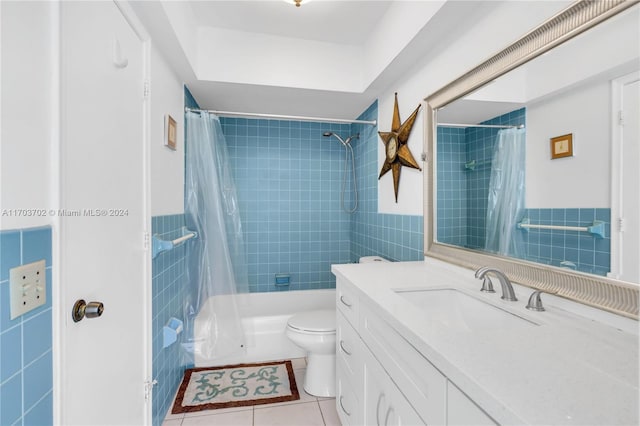 full bathroom featuring vanity, tile patterned floors, toilet, shower / bathtub combination with curtain, and tile walls