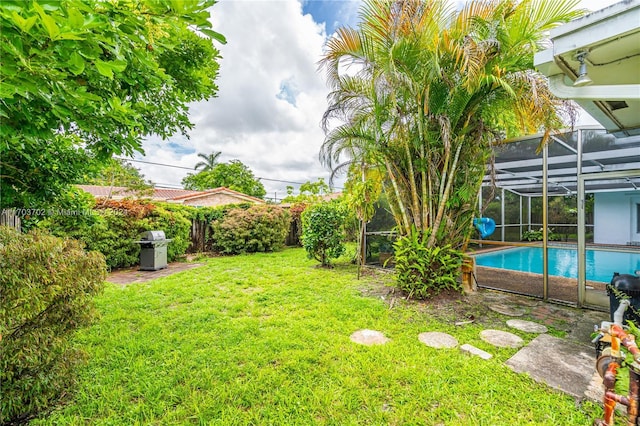 view of yard with a lanai and a fenced in pool