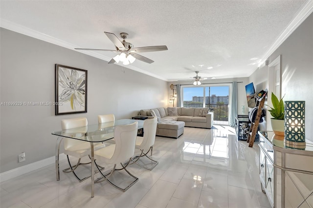 dining area featuring ornamental molding, a textured ceiling, baseboards, and a ceiling fan