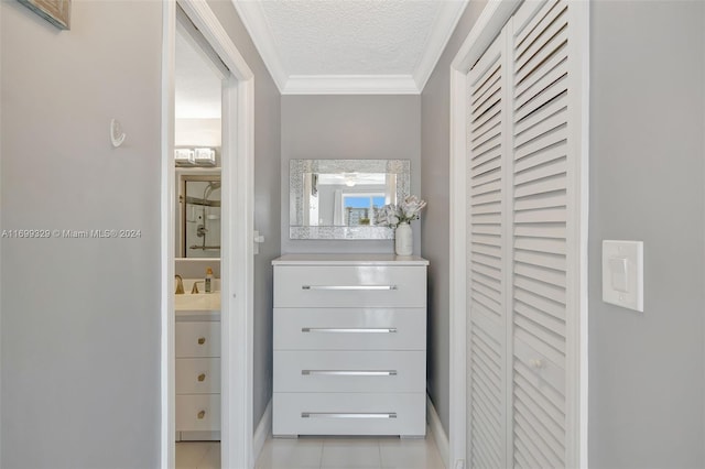 walk in closet featuring sink and light tile patterned flooring