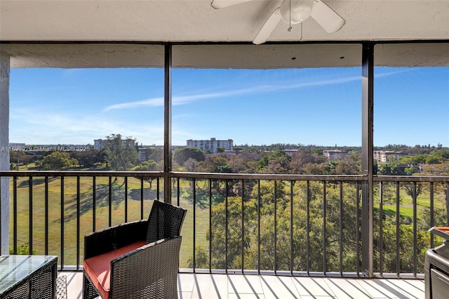 unfurnished sunroom featuring a ceiling fan