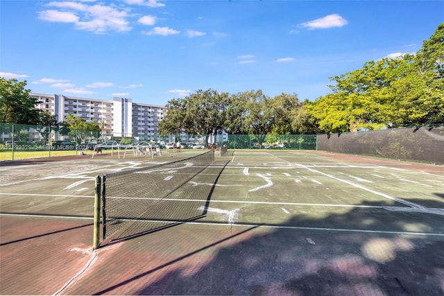 view of sport court featuring fence