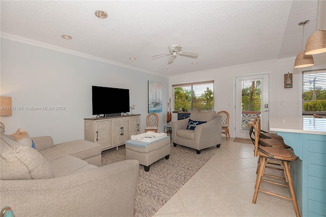 tiled living room featuring a textured ceiling, crown molding, and a healthy amount of sunlight