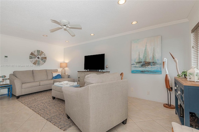 tiled living room with ceiling fan, a textured ceiling, and ornamental molding