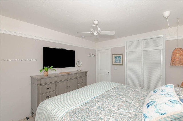 bedroom with ceiling fan and a closet