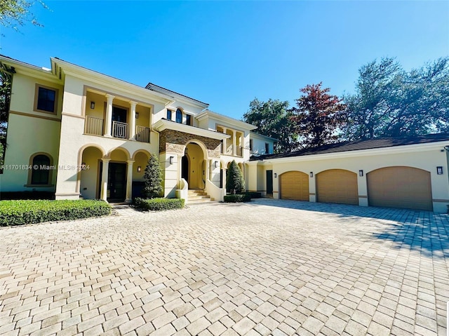 view of front of property with a balcony and a garage