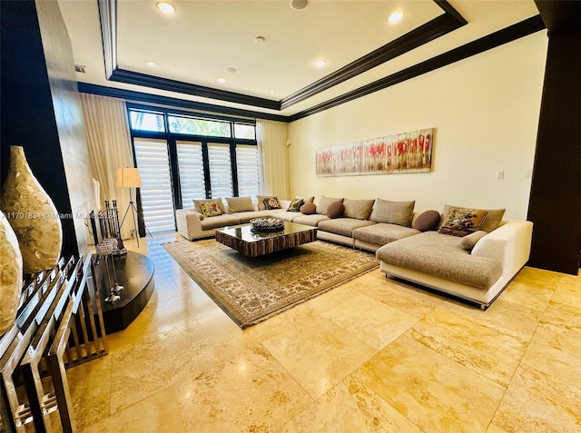 living room with a raised ceiling and crown molding