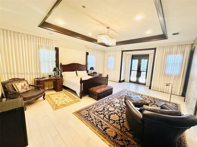 bedroom featuring access to outside, a raised ceiling, french doors, and an inviting chandelier