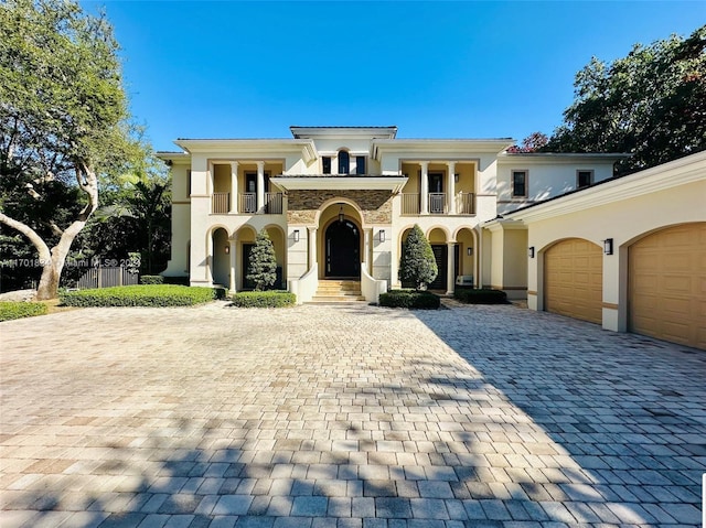 mediterranean / spanish home with a balcony and a garage