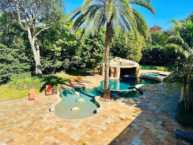 view of pool with a patio area and an in ground hot tub