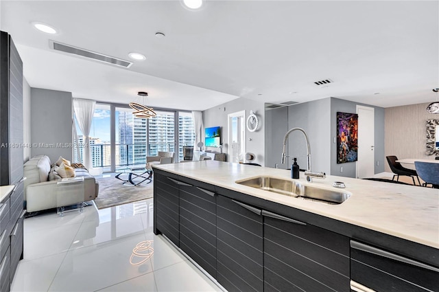 kitchen with sink, light tile patterned floors, and hanging light fixtures