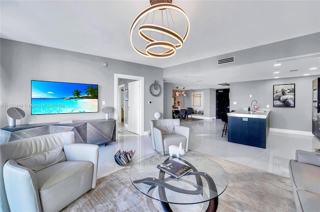 tiled living room with sink and a chandelier