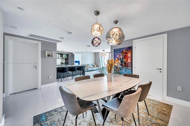 dining space featuring light tile patterned floors