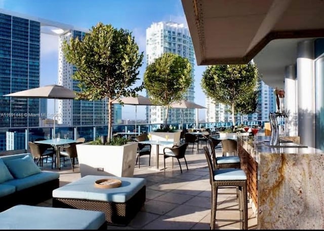 view of patio with an outdoor hangout area and a bar