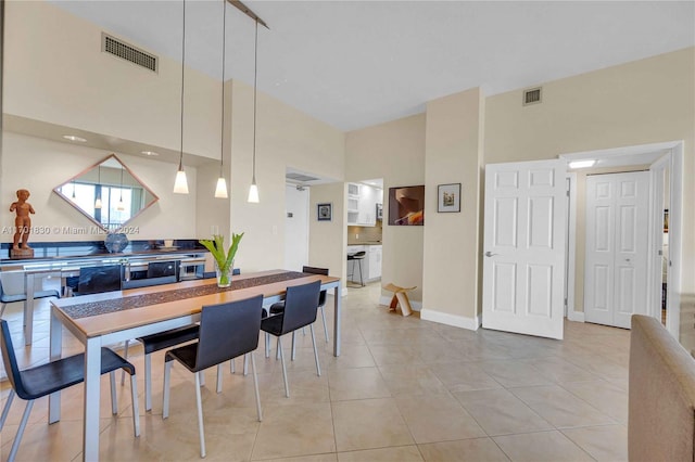 kitchen with light tile patterned flooring and decorative light fixtures