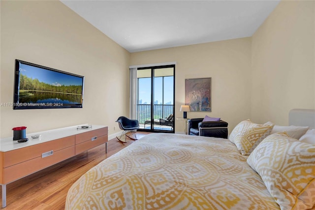 bedroom featuring light hardwood / wood-style floors and access to exterior