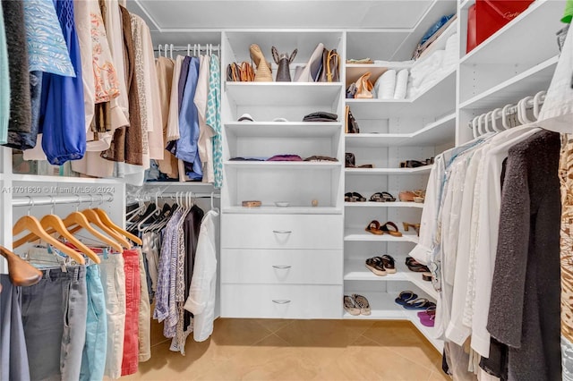 spacious closet featuring light tile patterned floors