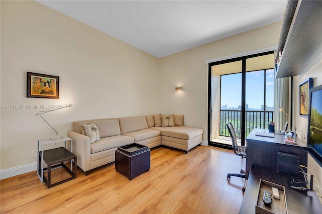 home office with light hardwood / wood-style flooring