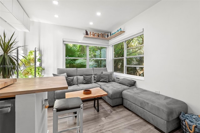 living room featuring breakfast area and light wood-type flooring