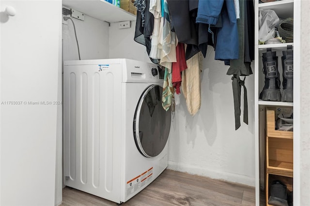 laundry room with wood-type flooring and washer / dryer