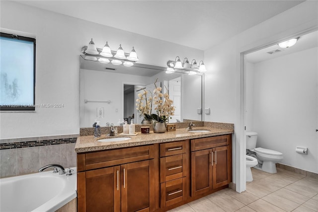 bathroom with tile patterned floors, vanity, a bath, a bidet, and toilet