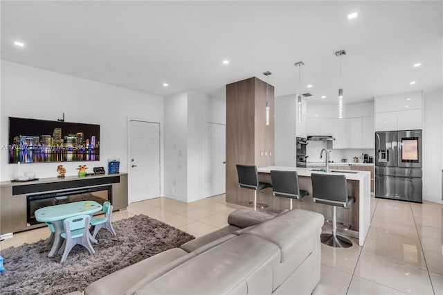 living room featuring light tile patterned floors and sink