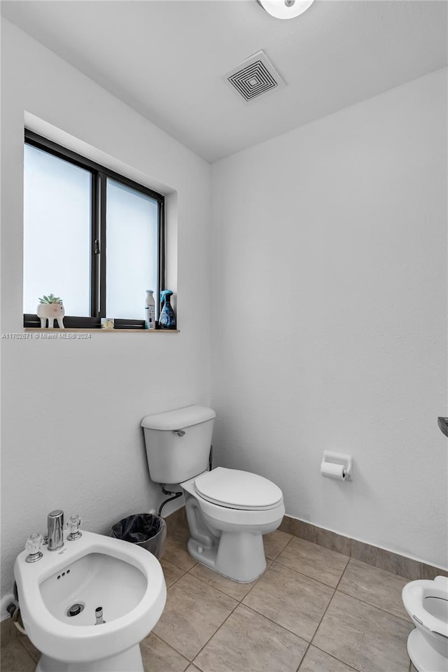 bathroom featuring tile patterned floors, a bidet, and toilet